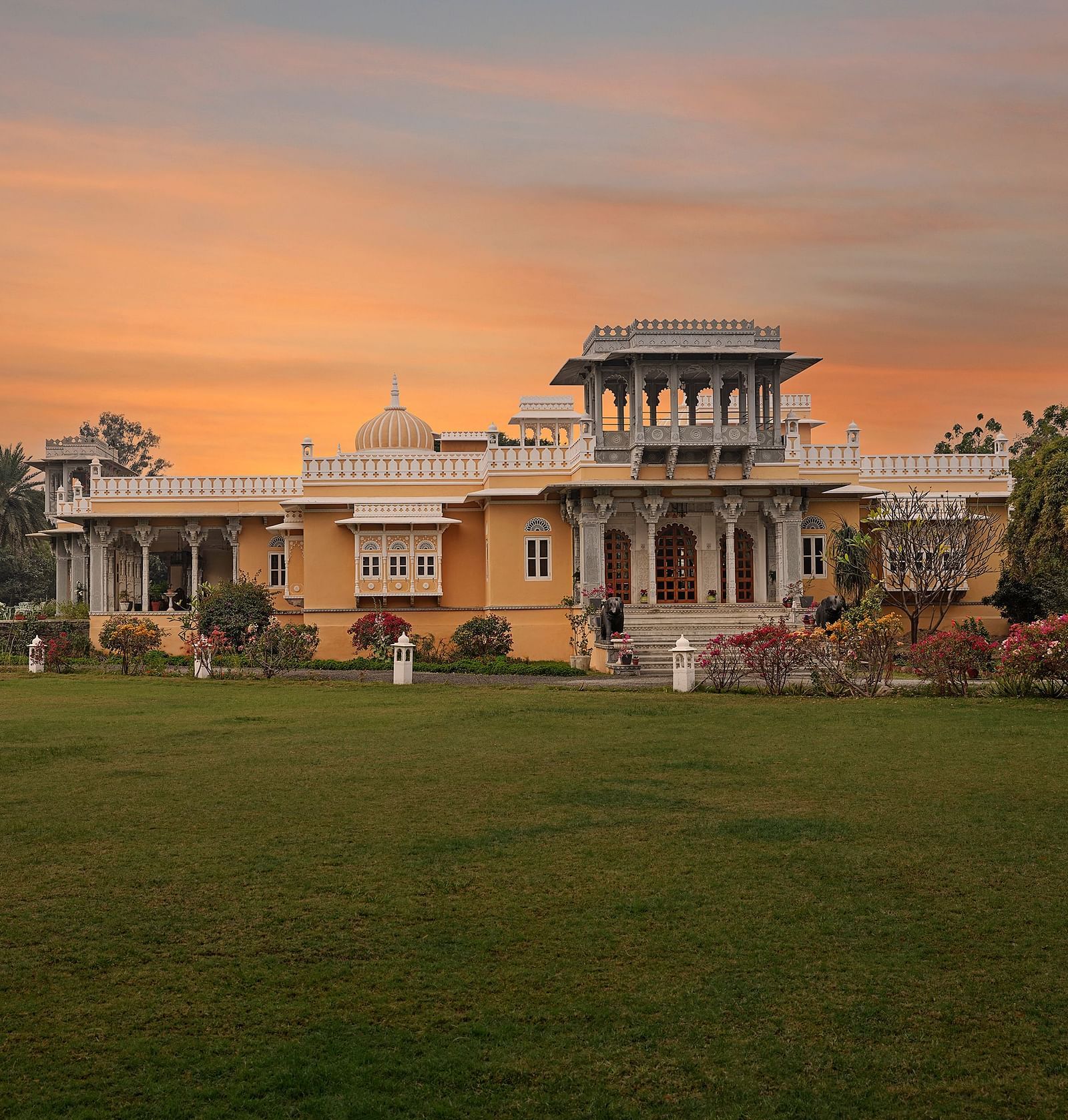 facade image of dev shree, deogarh with a sunset in the background