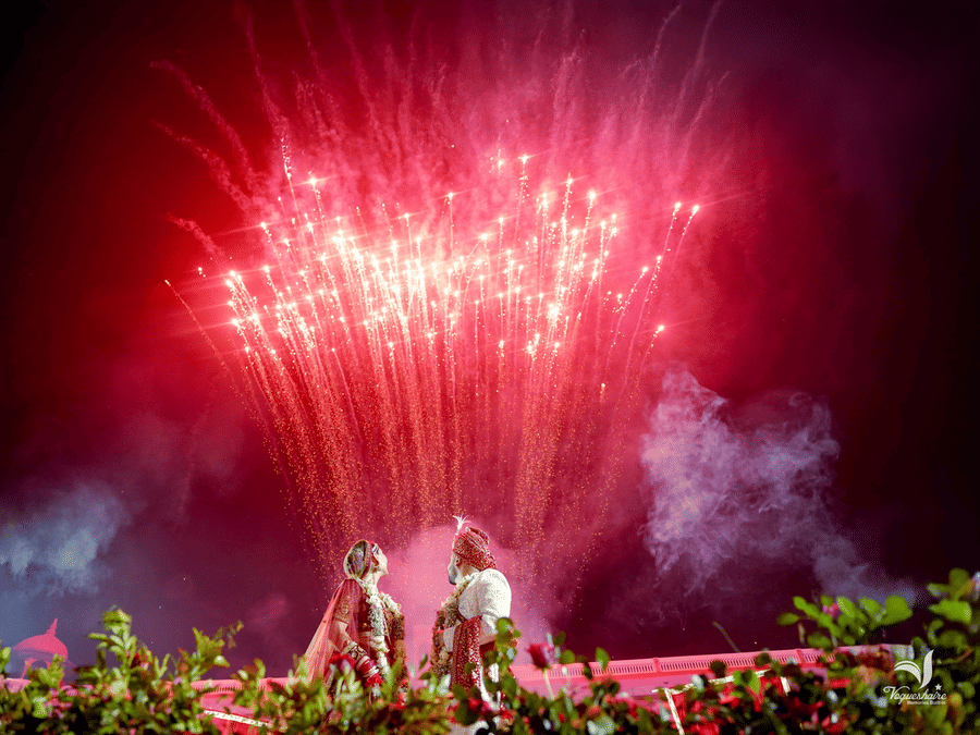 Grand fireworks display lighting up the sky during a wedding celebration at Umaid Palace.