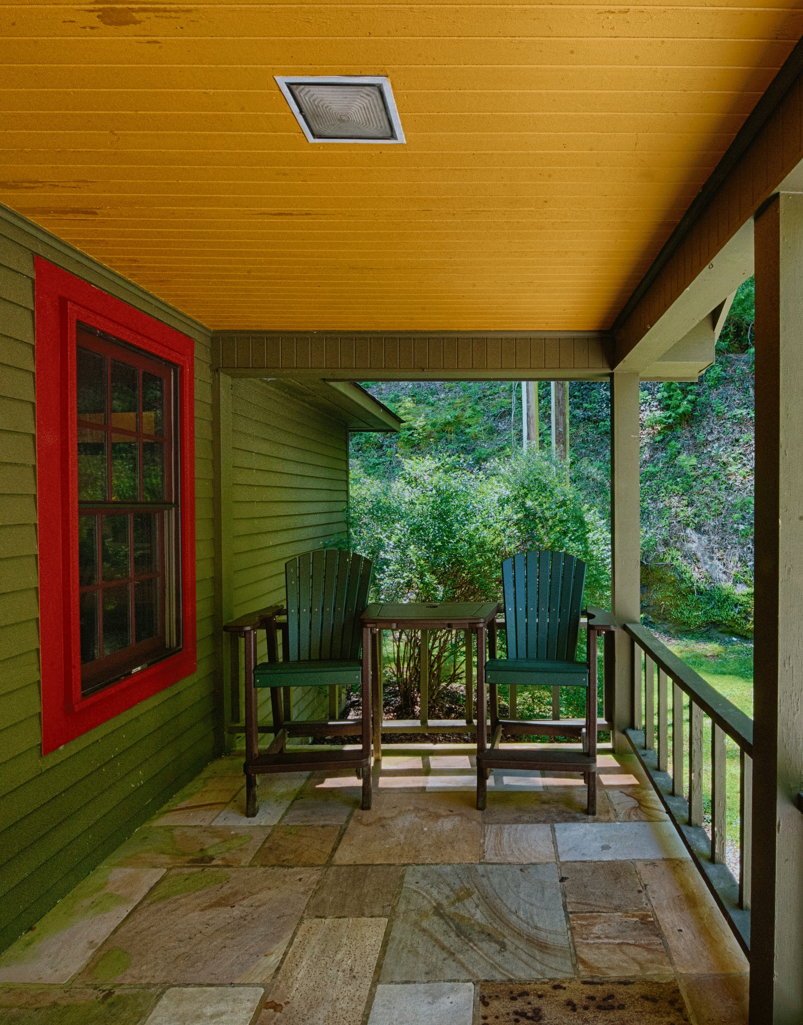 exterior of the cabin named Santeetlah Four with a spacious porch overlooking the empty space in front of it - Historic Tapoco Lodge