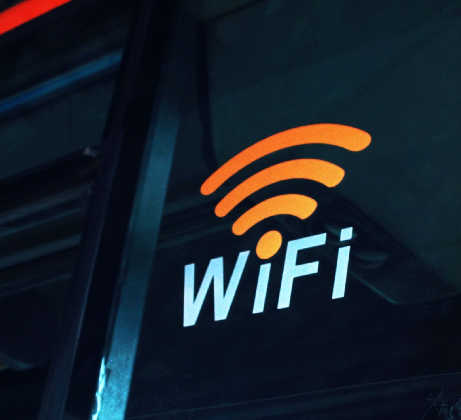 A wi-fi symbol with the words wifi on a bus placed on a plastic exterior