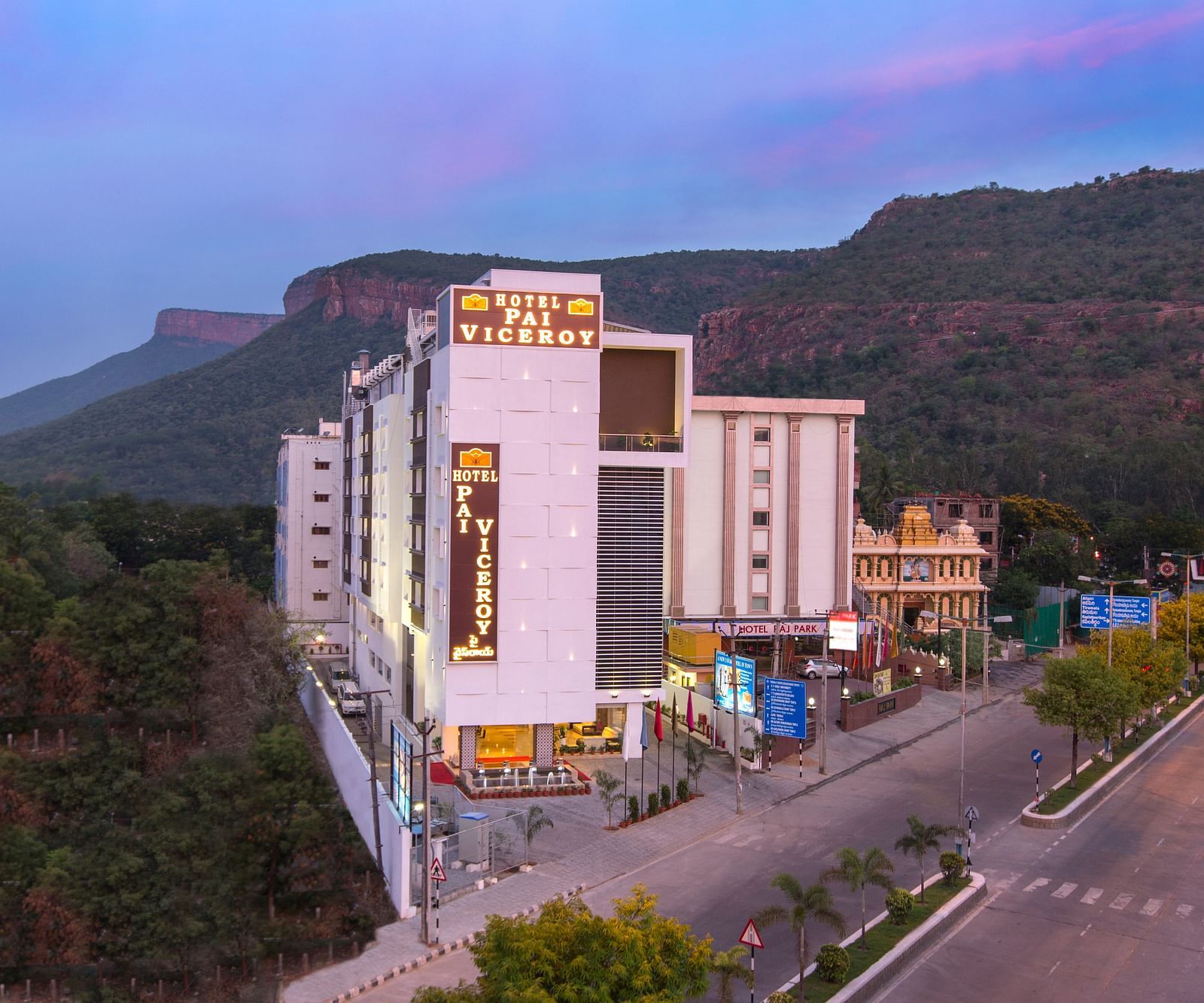 A image of a Hotel Pai Viceroy Tirupathi builiding which is set amidst the hills and greenery 