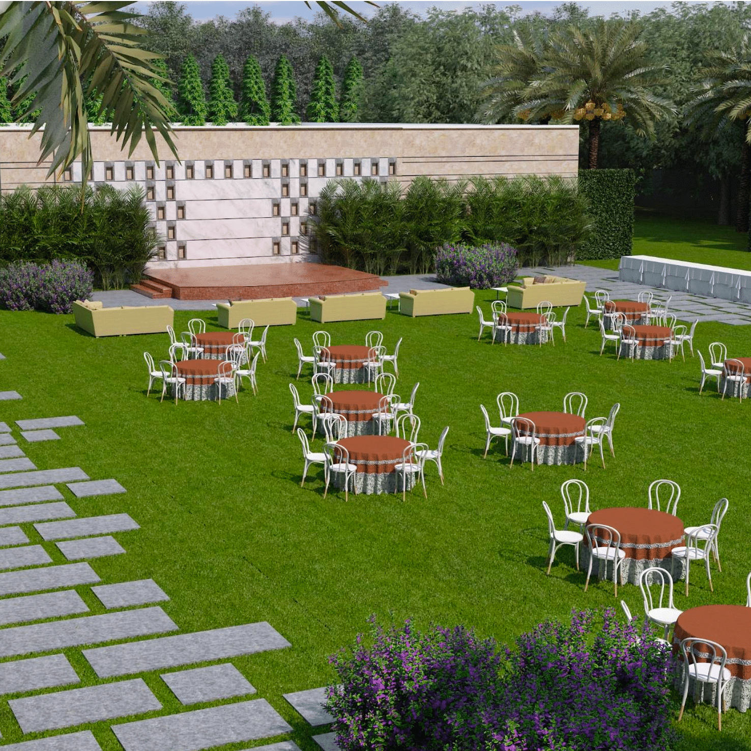 A lawn area with chairs and tables, a stone pathway and palm trees on either side