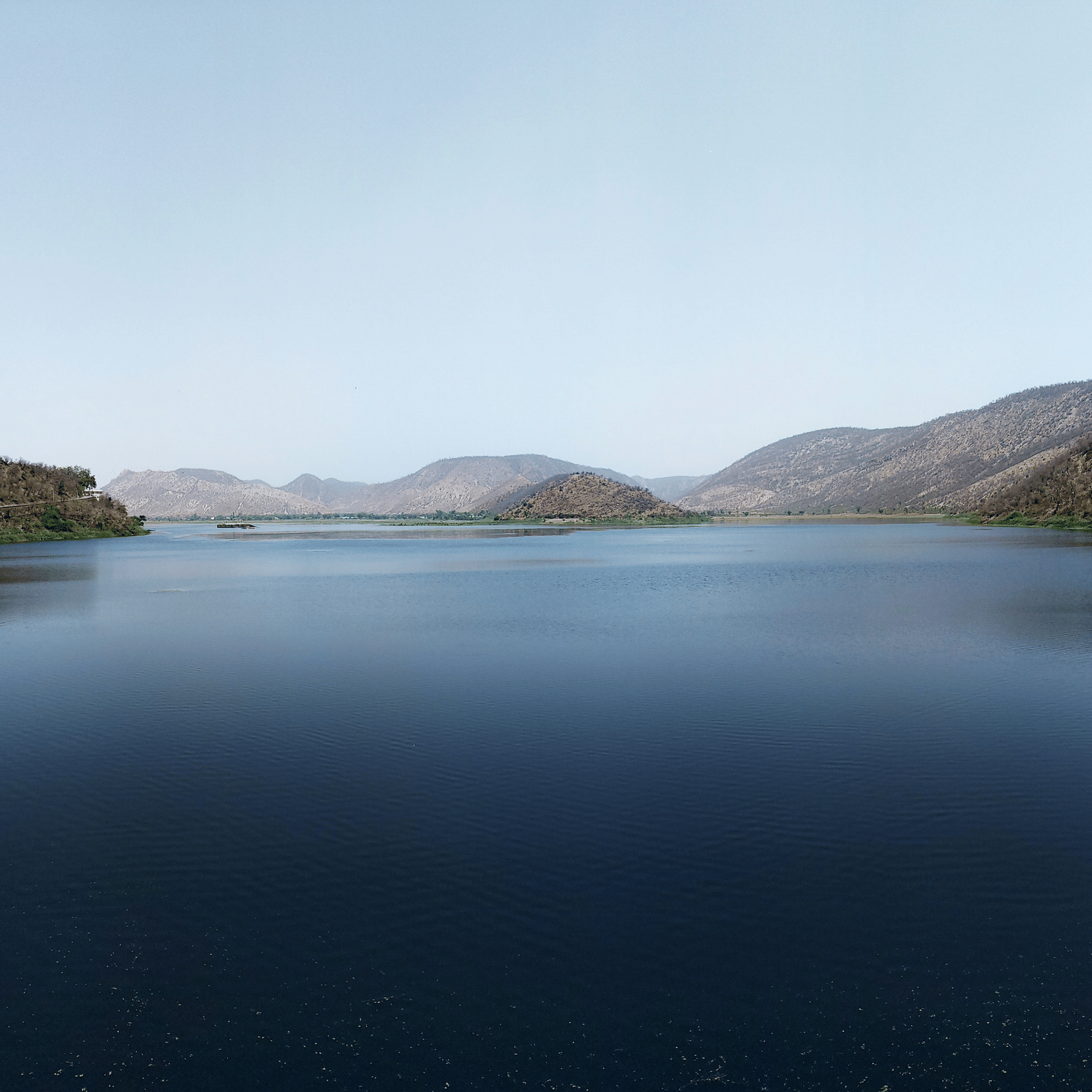 An overview of Siliserh Lake with mountains surrounding the lake.
