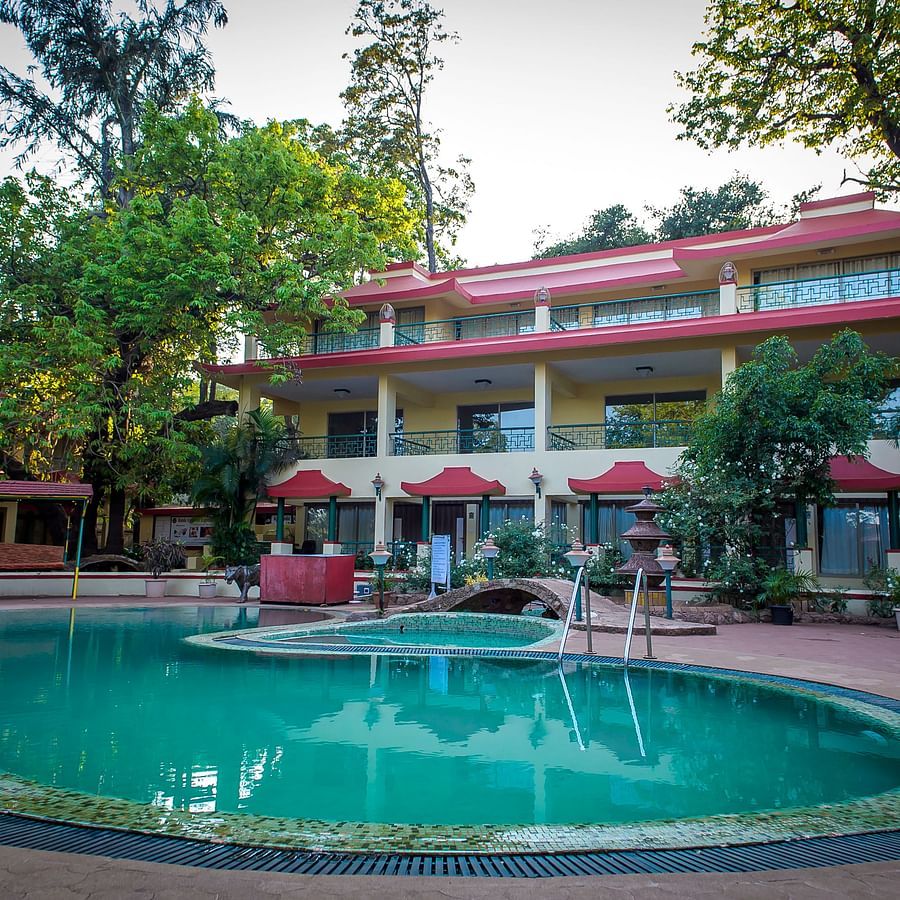 Picture of Pool with big building in the background - Adamo Resort Matheran