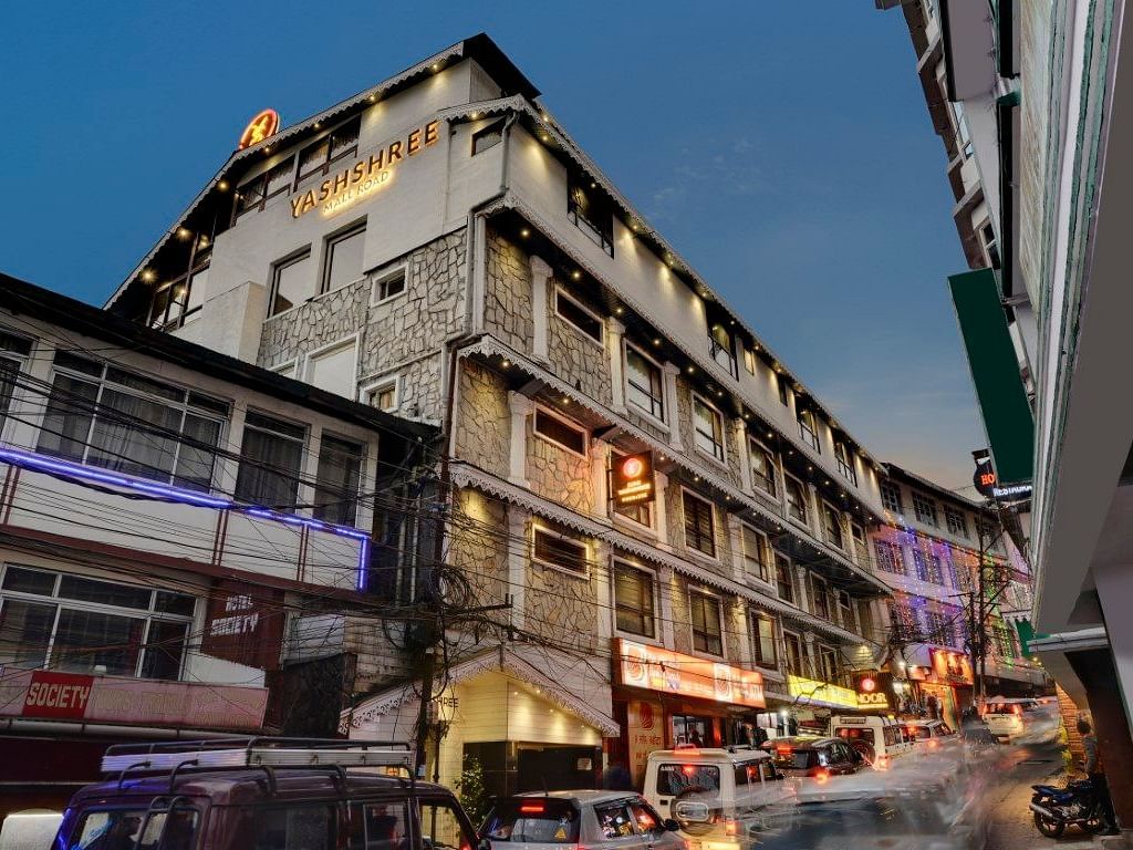 Facade of Yashshree Mall Road, Darjeeling with cars in plying in front of the building.