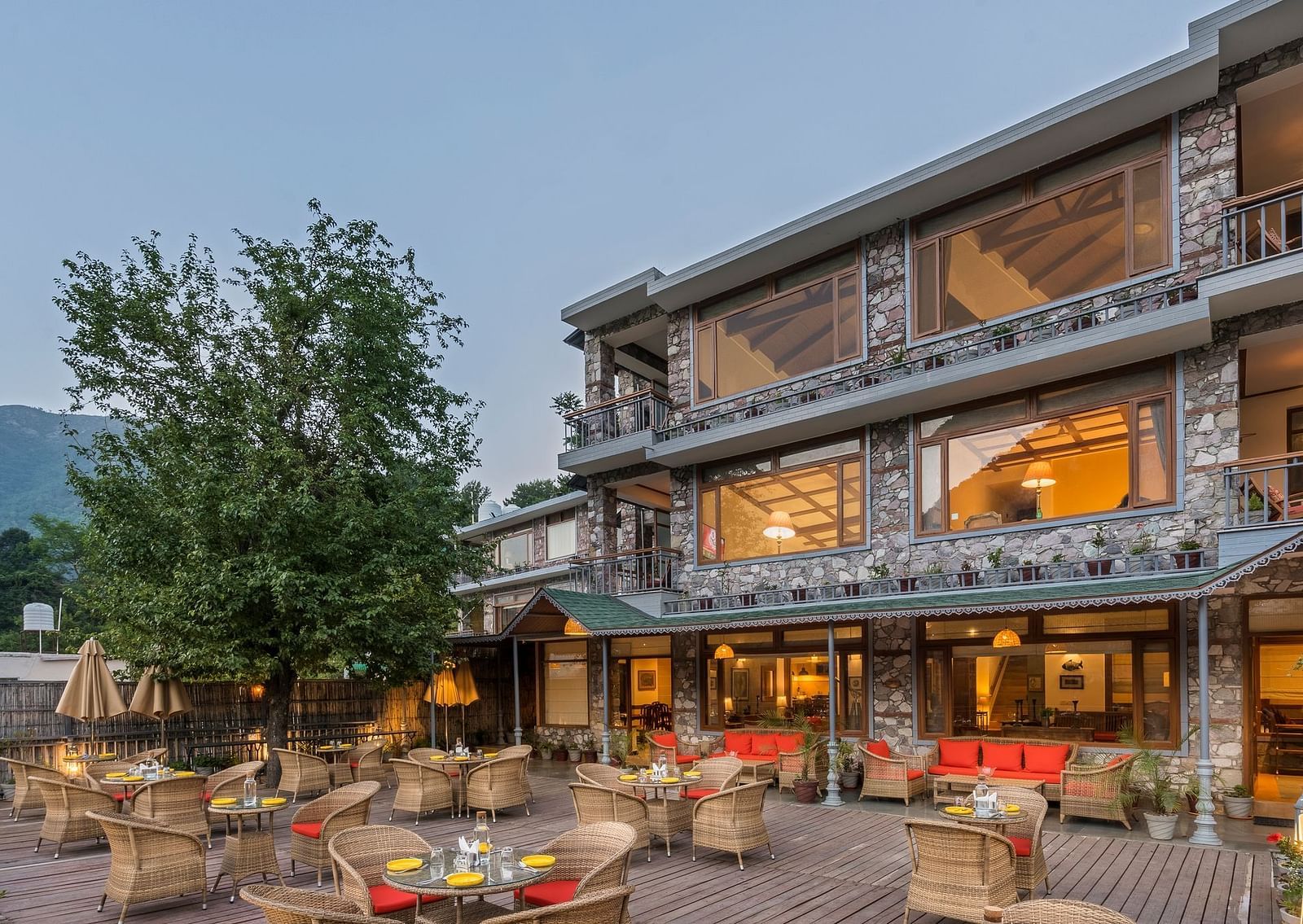 Outdoor restaurant at Fishermen's Lodge, Bhimtal, featuring a beautiful view, creating a perfect setting for dining in nature.