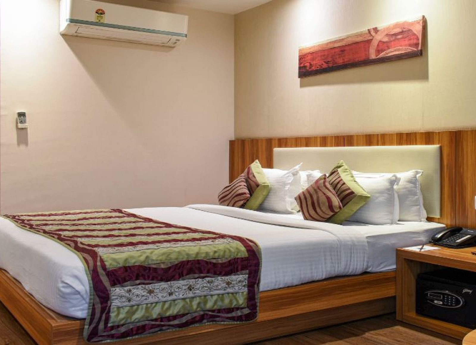 Corporate room with a posh bed and warm lighting captured from different angles while showcasing the in-1room amenities - the Le Roi Raipur Hotel