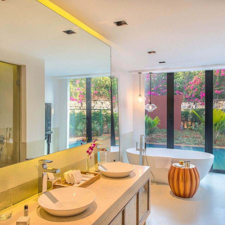 alt-text Bathroom with white ceramics, clean interiors and a large mirror