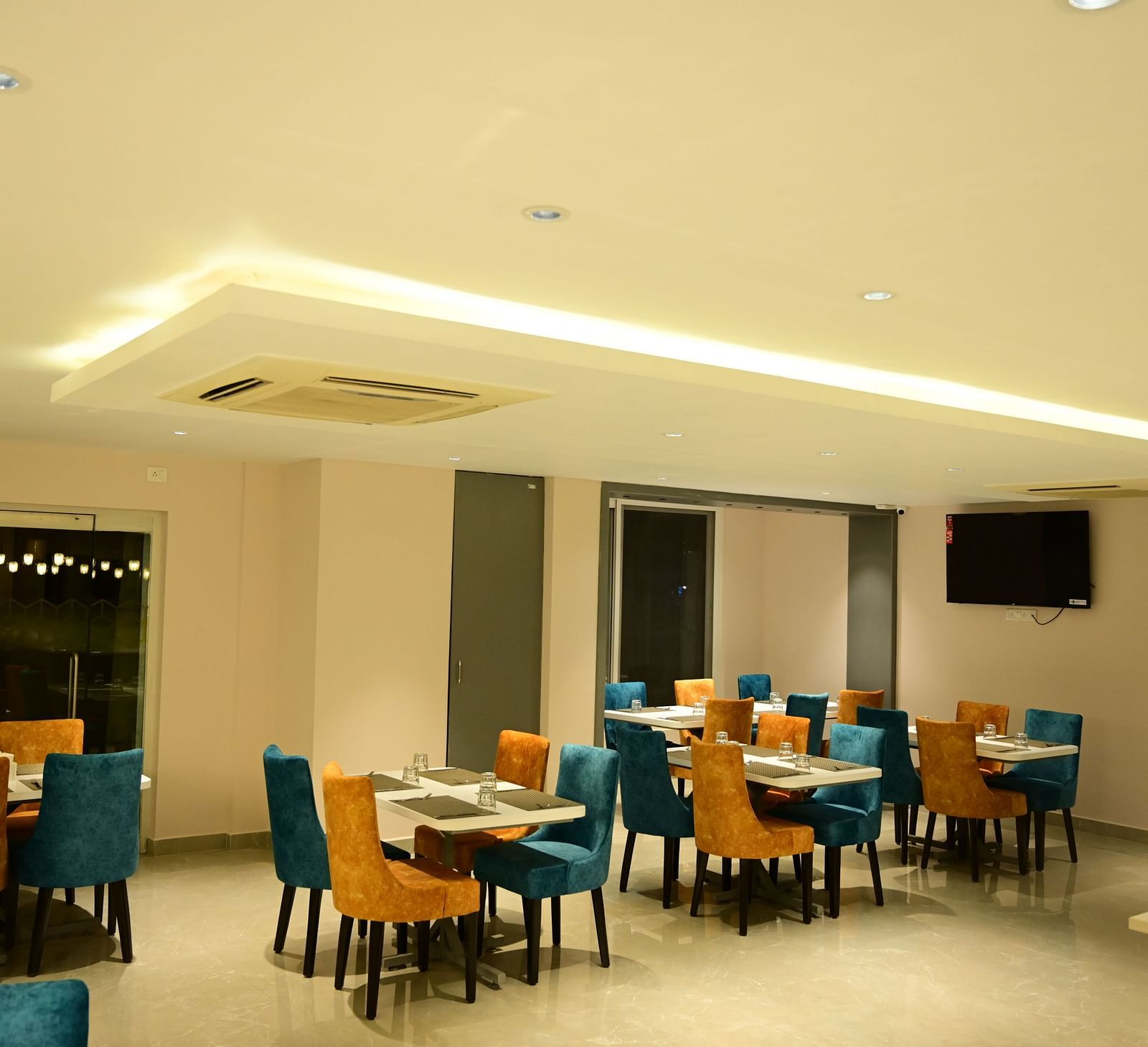 Blue and Yellow coloured chairs at the restaurant at Sterling Keys by TGI in Bnagalore