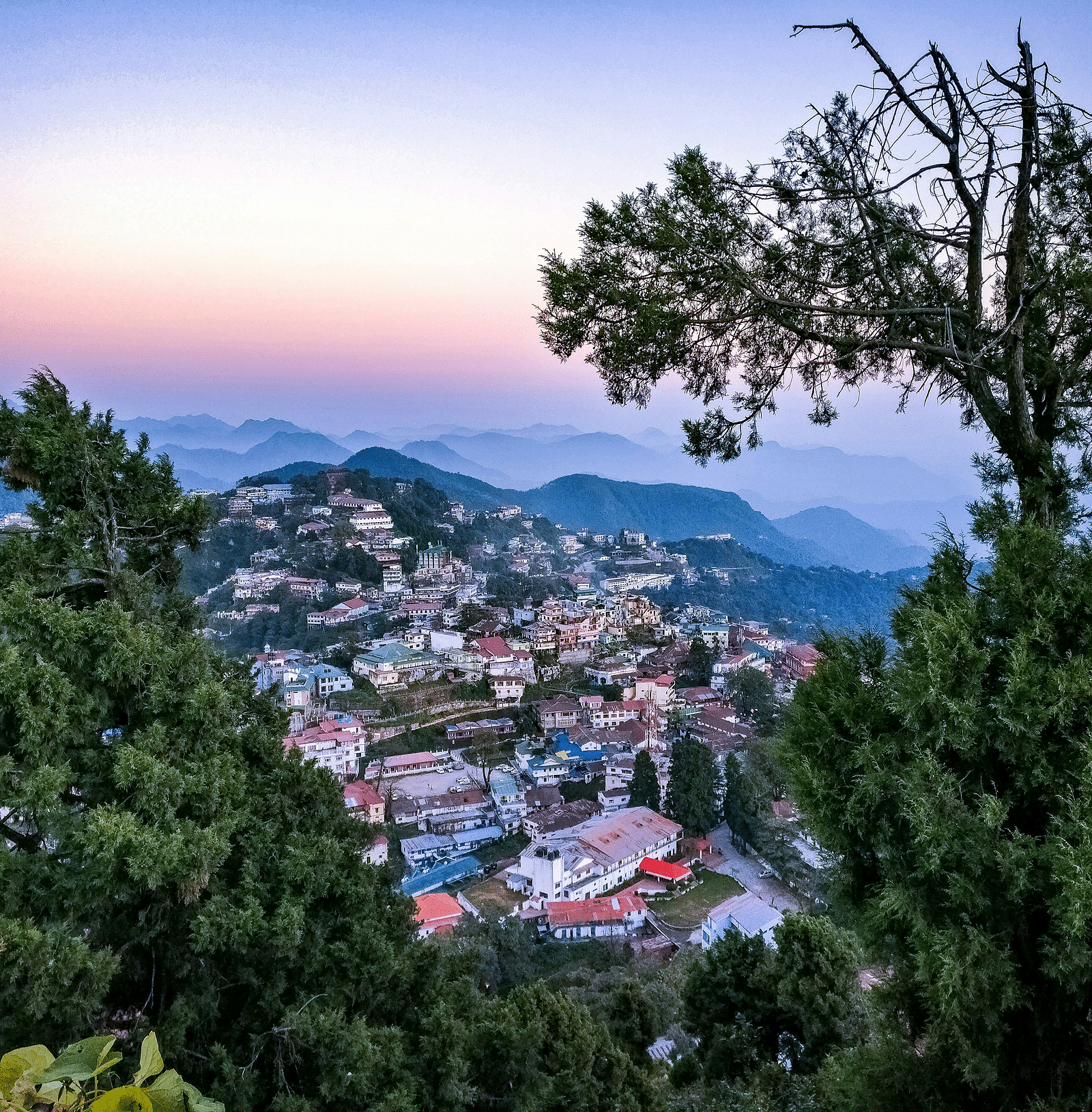 a bright facade image of a town from a hiltop