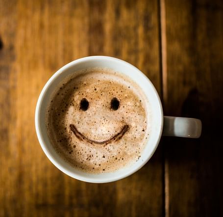 A coffee cup with a simile seen from the top - Brewery Gulch Inn & Spa