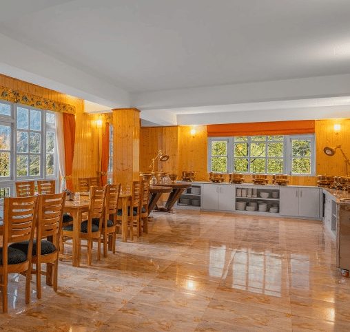 Image of a restaurant with sitting area and view of the mountain in front at Summit Gangchen Hotel, Lachen