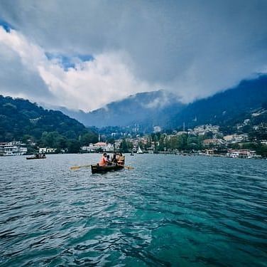 boat in a blue lake with mountains around it