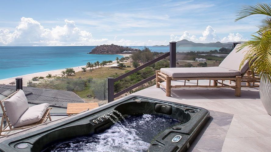 Rooftop terrace with black jacuzzi tub and ocean view at Tamarind Hills Resort and Villas - Antigua.