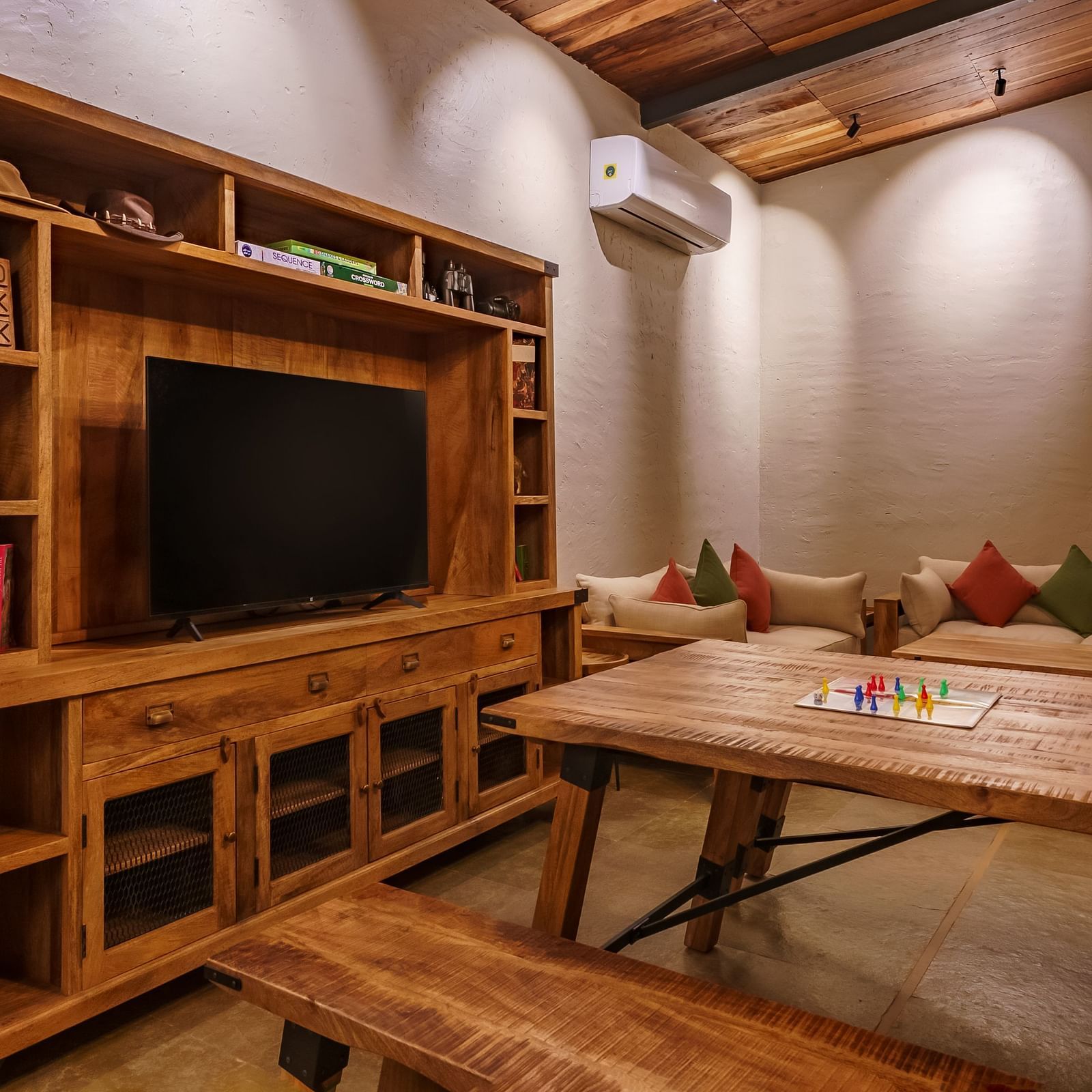 The wooden furnished dining area with TV at Trees N Tigers, Tadoba.