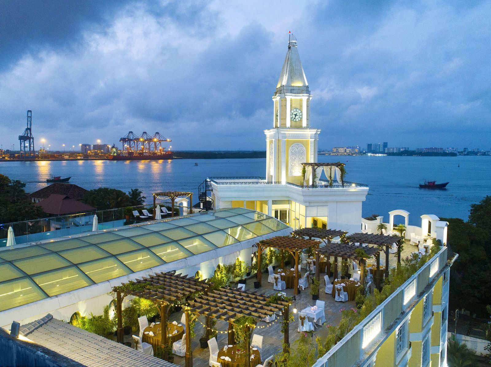 Aerial view of the hotel with a cloudy sky and a beach view.