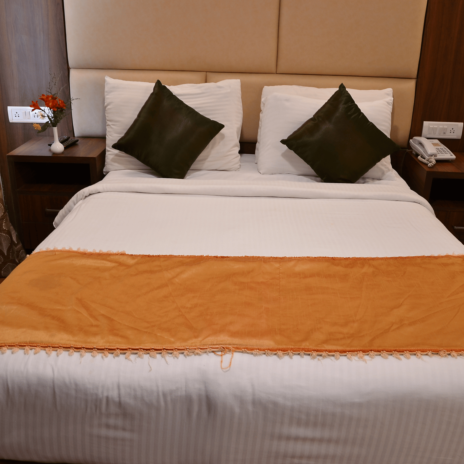 A comfortable bedroom with soft lighting, plush pillows, and a warm colour scheme for restful nights - Benzz Park, Kodaikanal