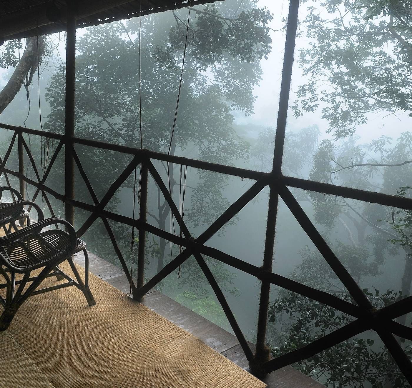 Two chairs in a balcony with forest views | Vythiri Resort. Wayanad