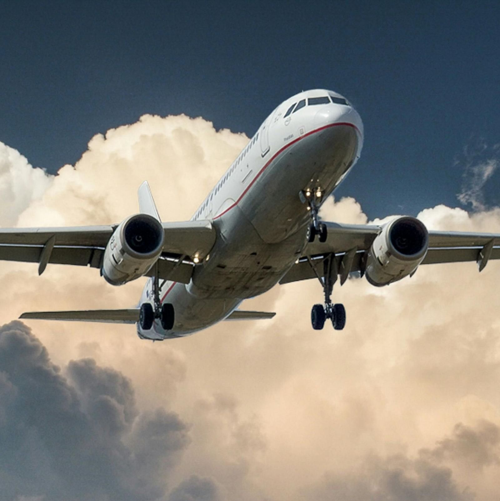 An aeroplane soaring through a heavily clouded sky