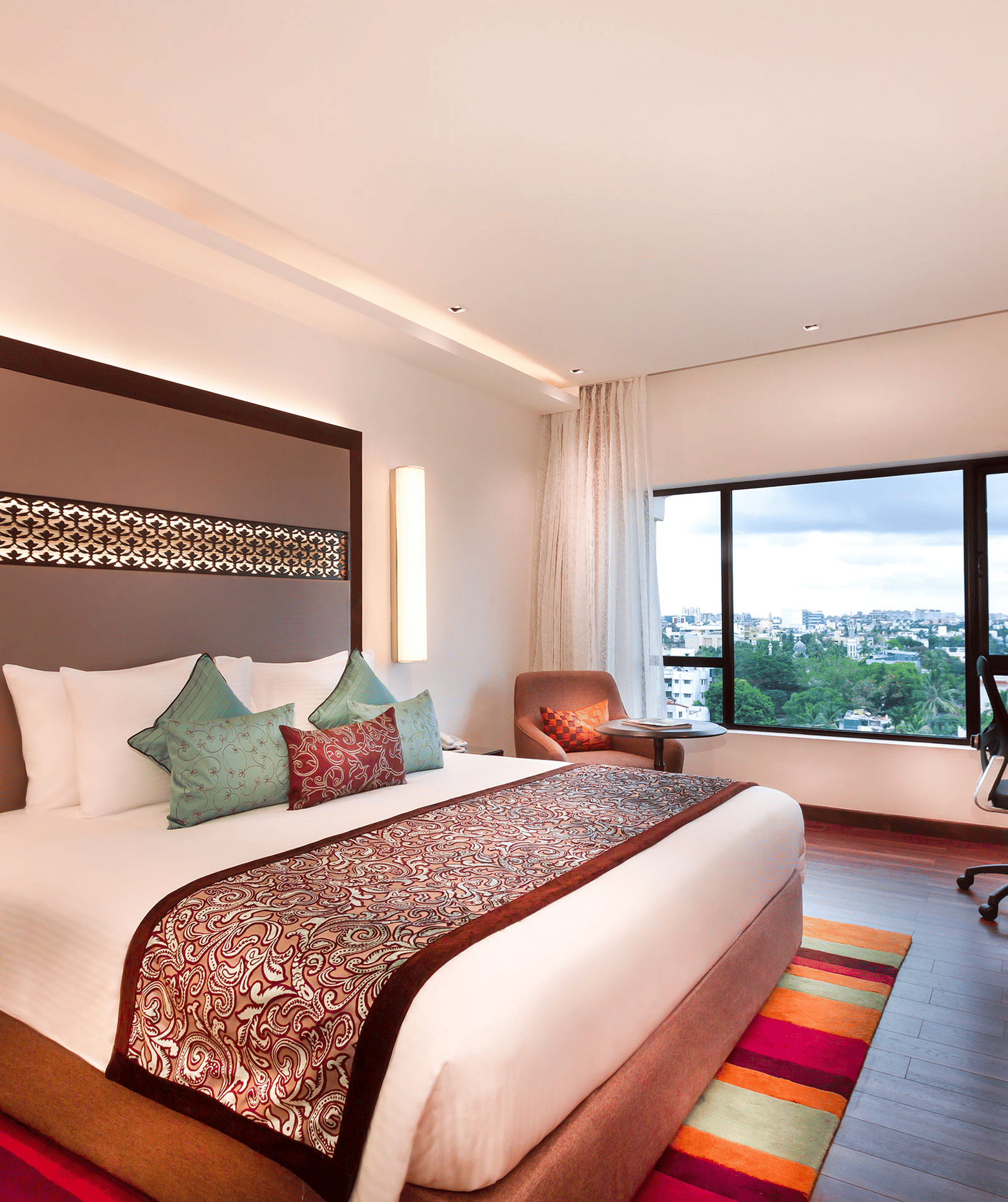 Serene Room with a king size bed and a work desk with a chair at Grand Chennai By GRT Hotels.