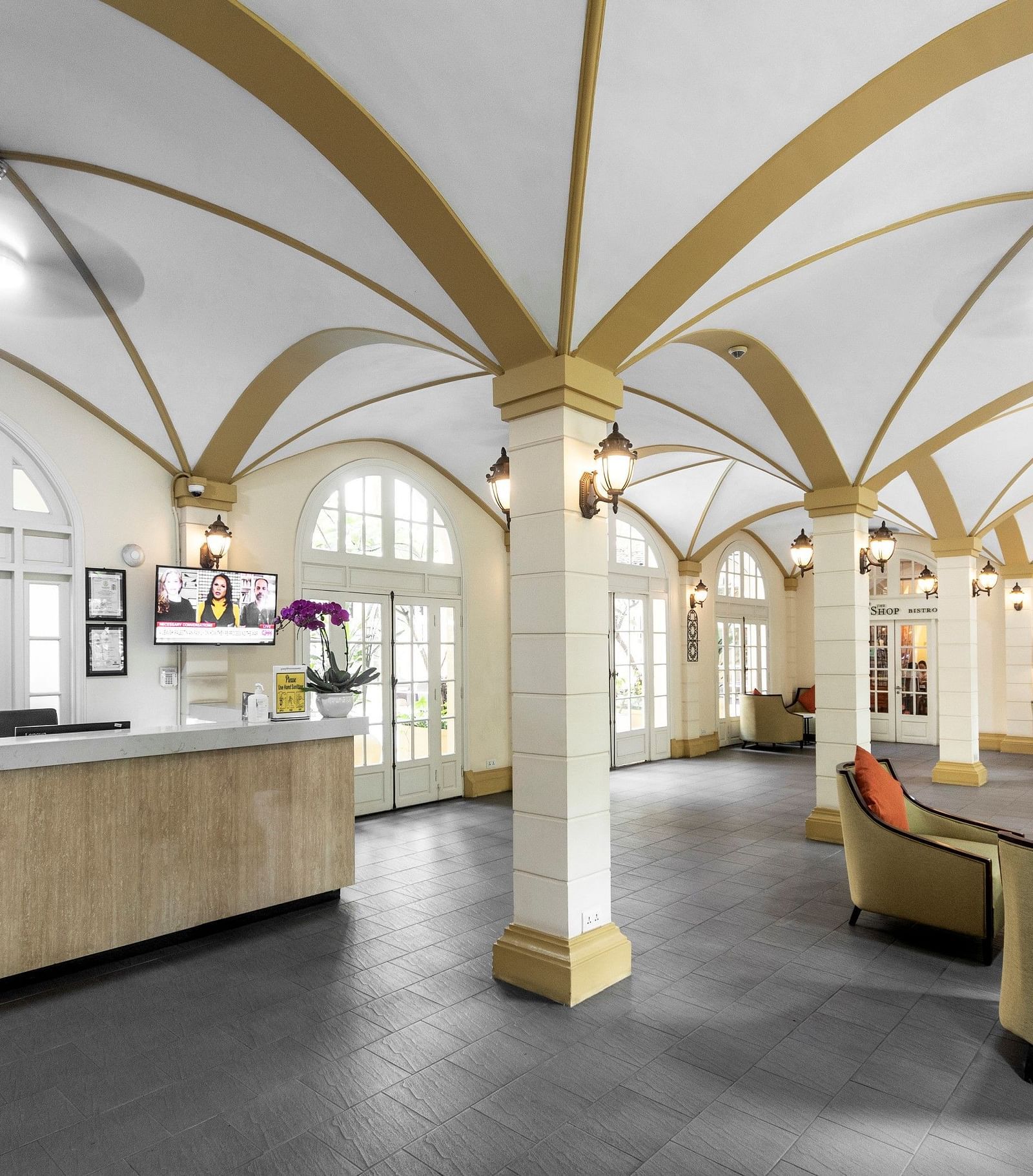 An interior shot of a lobby with high, arched ceilings and elegant furniture | Central Mansions, Phnom Penh