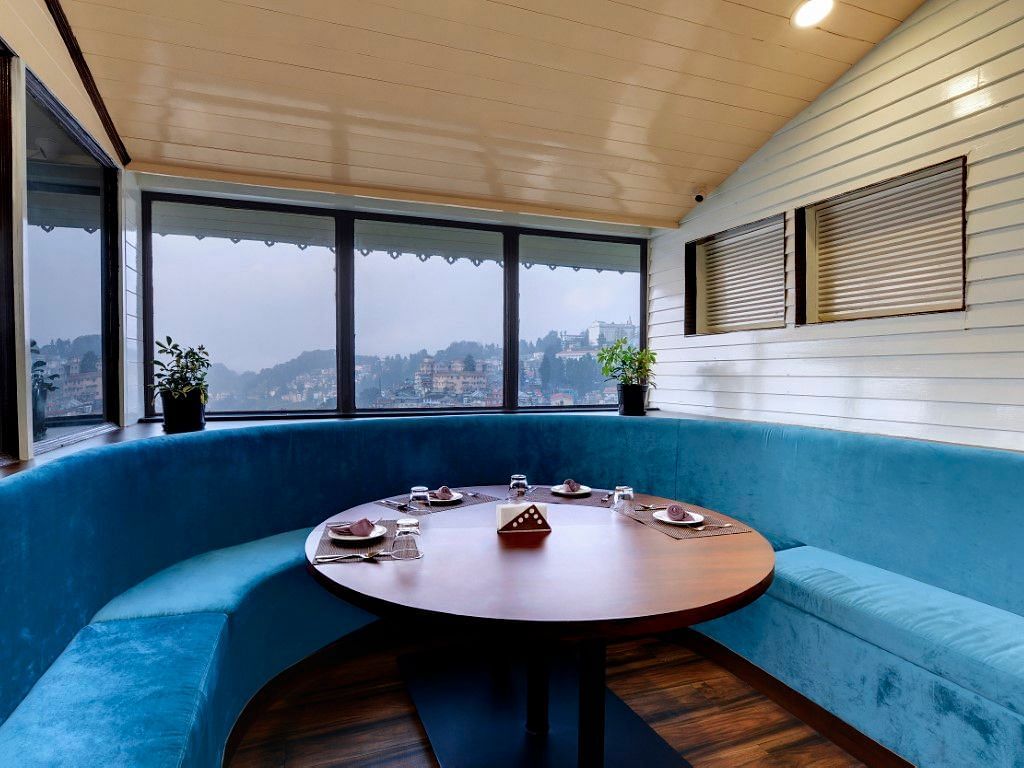 Lobby image of Sumitel Darjeeling featuring a round lounge seating with a round table