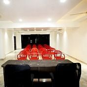 A spacious hall with tables and chairs arranged neatly at SeaFort Beach Resort