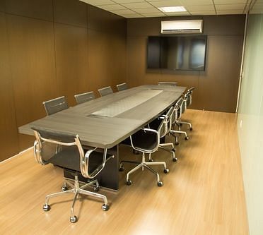 Modern conference room with a long table and chairs | Senate Boardroom | Woodstock Resorts, Coorg