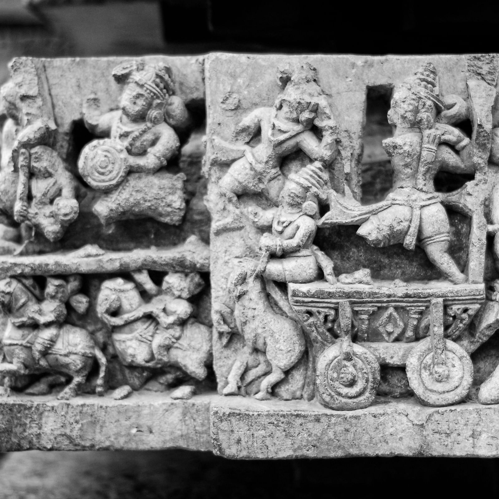 stone carvings at a wall in a temple from the hoysala dynasty