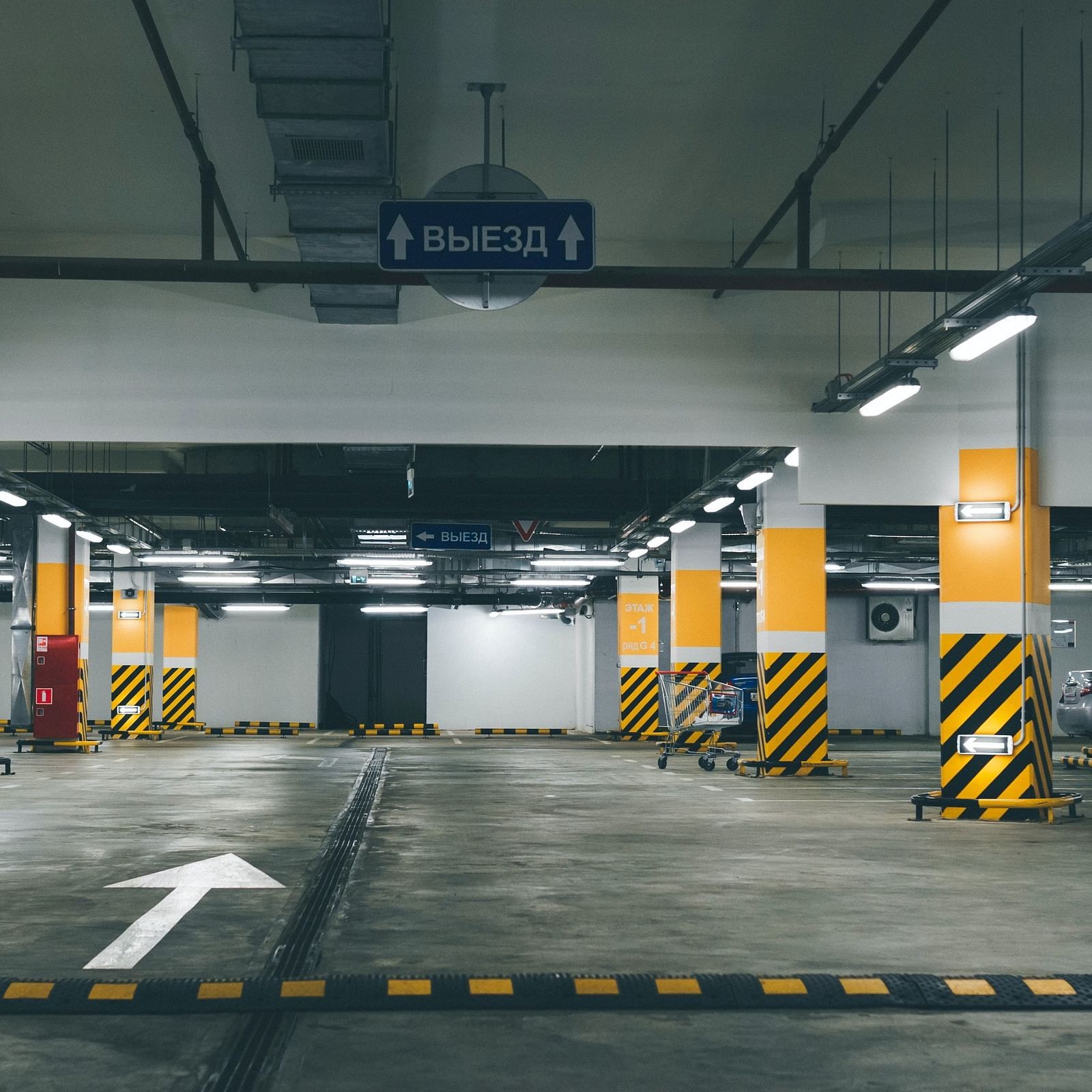 An empty parking lot with beams having reflective stickers on them