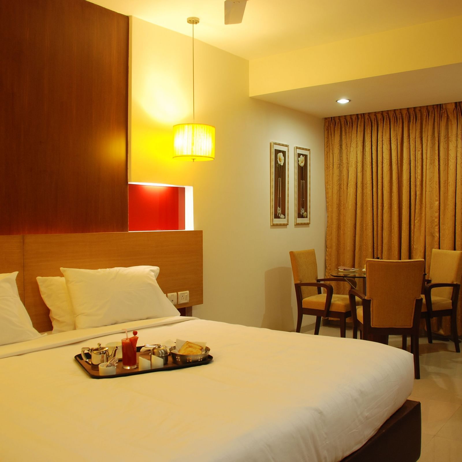 Luxury room with bed and seating area and bed at The Oriental Residency 