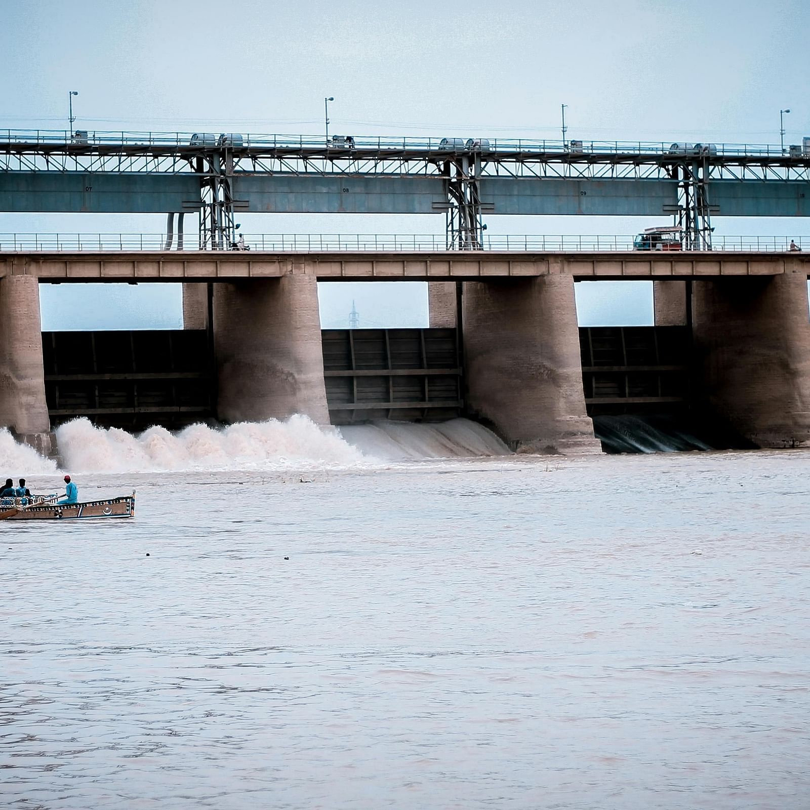 A dam with a serene water body, where a boat gently floats on the surface.