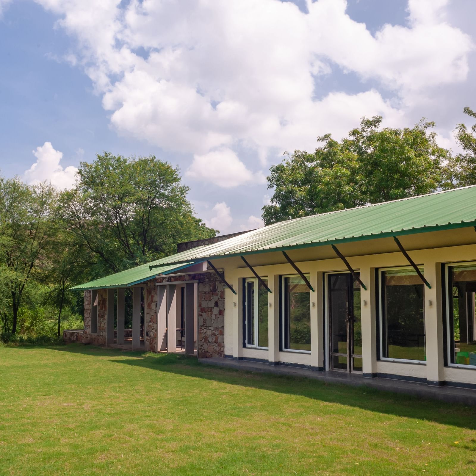 An exterior view of the cottages during the day at Trees N Tigers