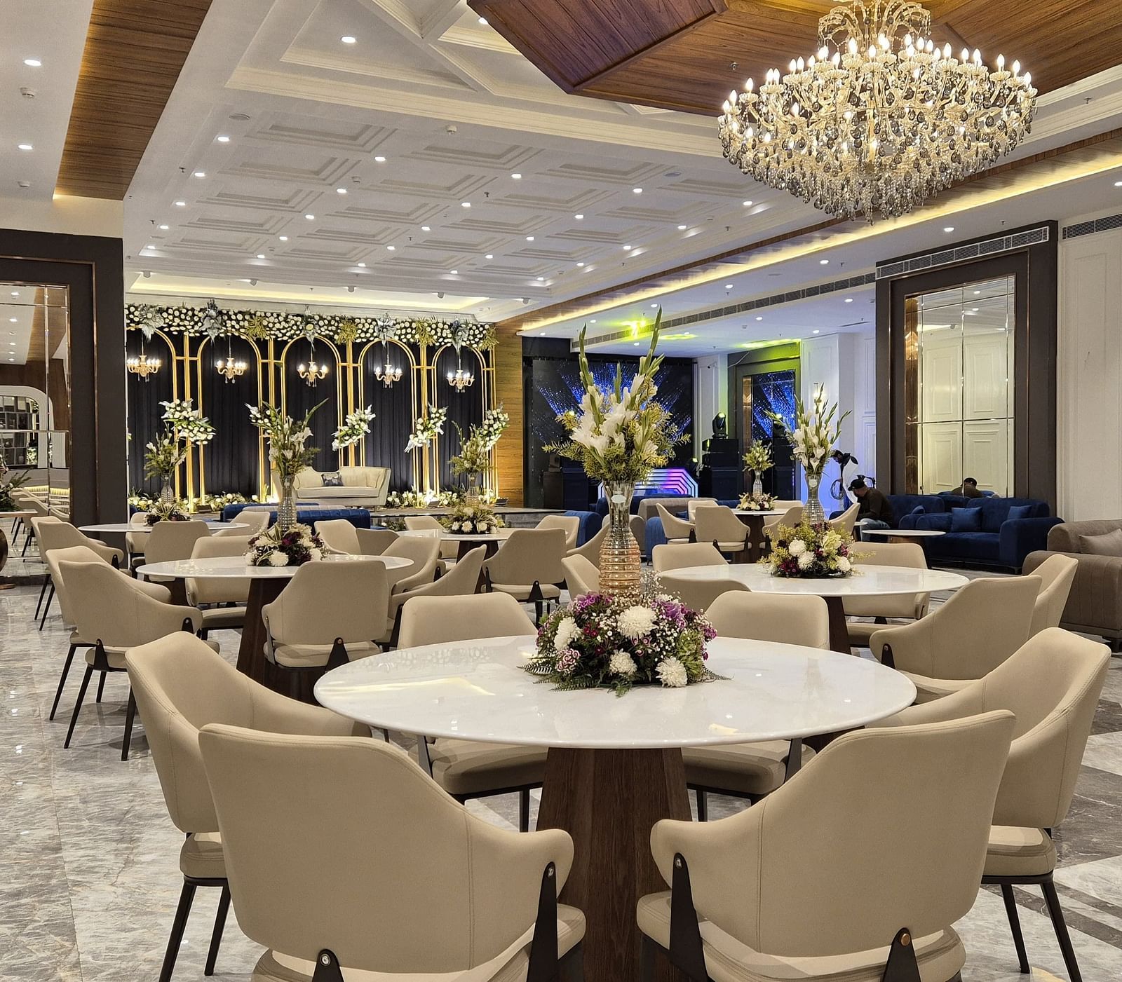 Elegant event space with chandelier lighting and neutral-toned seating, showcasing a sophisticated setting at Ramada by Wyndham Sonipat Murthal