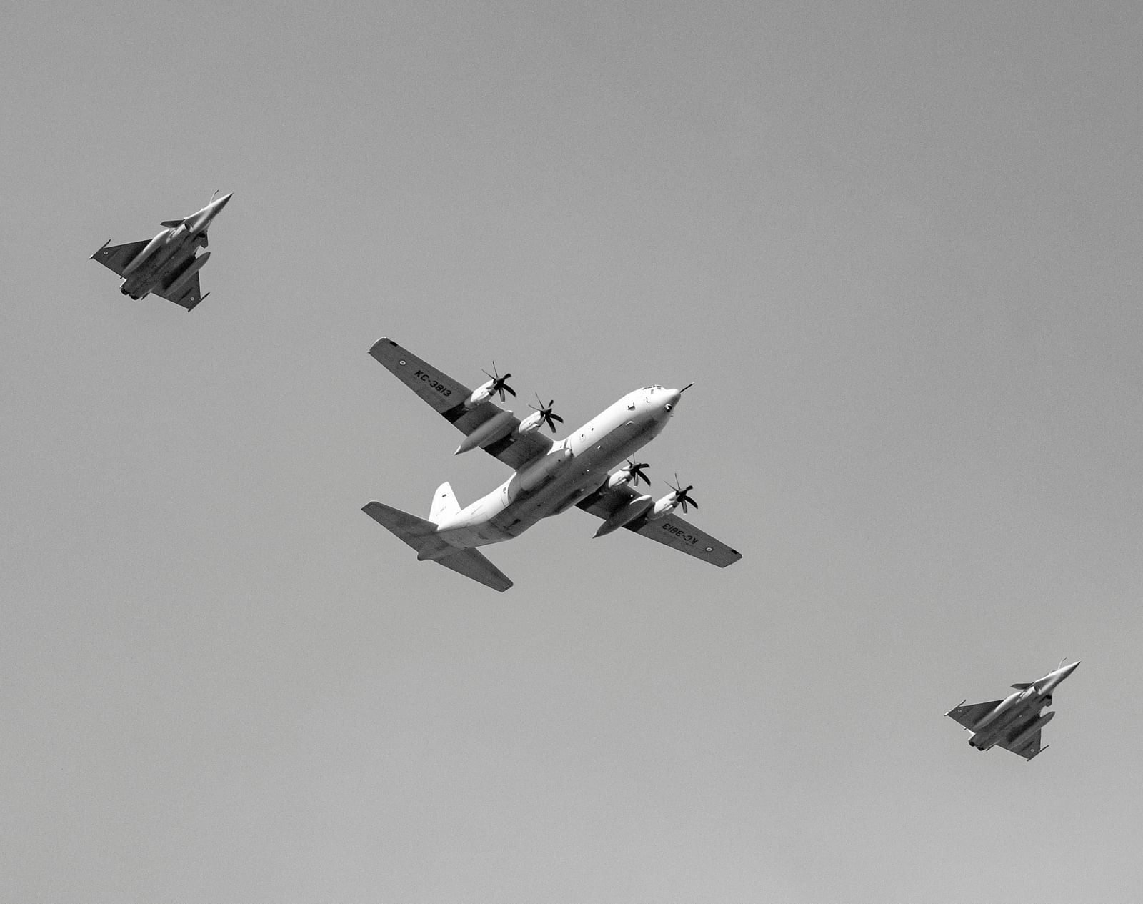 An airborne plane flying together with four other fighter jets.