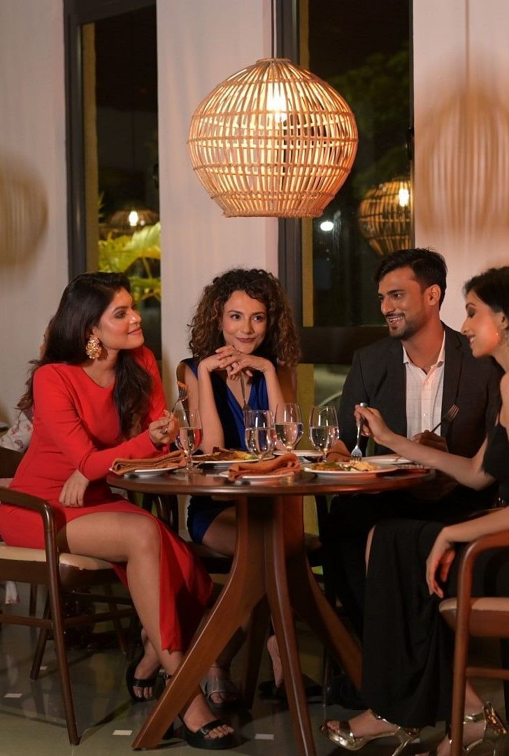 People having food and drinks at the indoor dining area at Singalila Club
