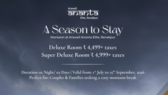 A grand palace style luxury resort building with illuminated windows and a fountain driveway under dramatic grey monsoon clouds, advertising seasonal rooms in Bundi.