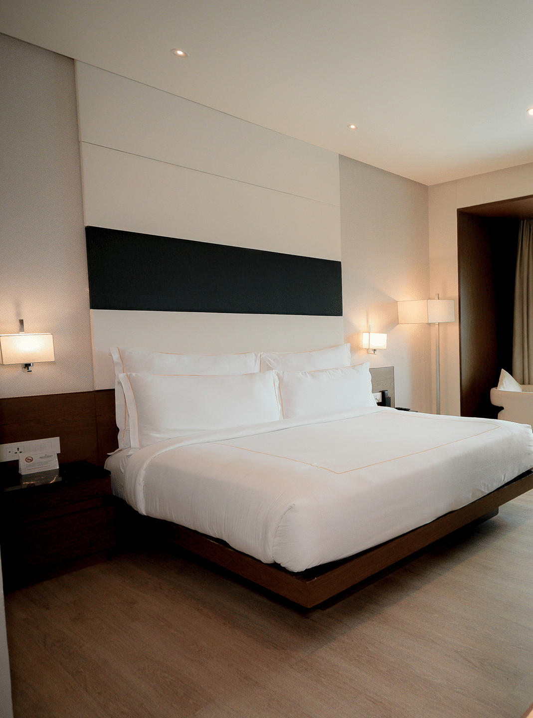 Spacious hotel room with modern furnishings and natural lighting – Narayani Heights Hotel & Resorts