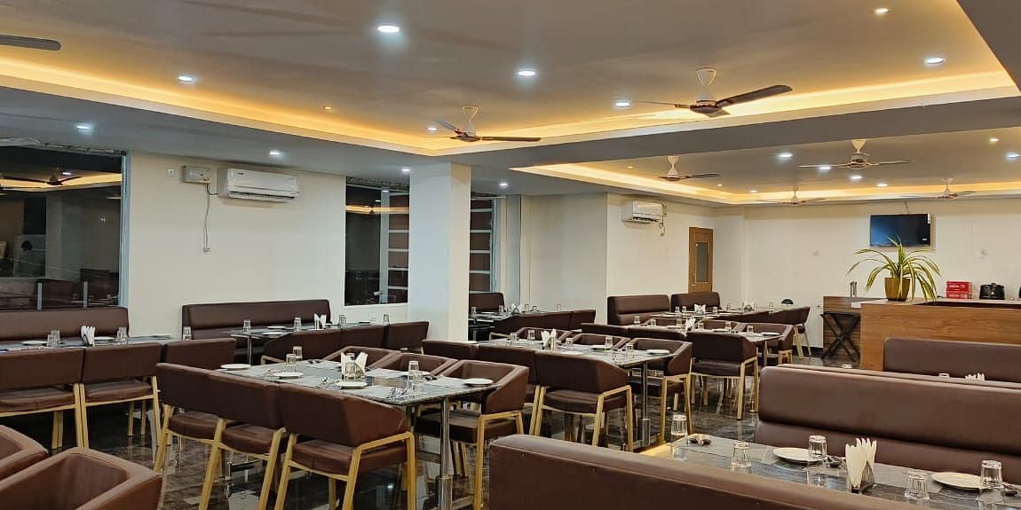 Dining arrangement in a restaurant at ANS M Square Hotel & Resort, Kalaburagi