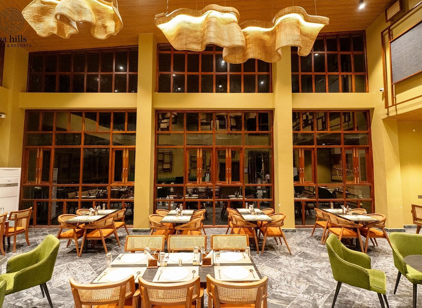 A modern dining space with large windows, stylish furniture, and an inviting atmosphere, designed for a comfortable dining experience - Sea Hills Resort, Swaraj Dweep (Havelock)