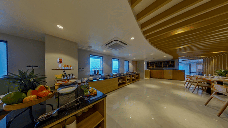 A dining area featuring its seating and fruit counter under lighting | Lords CBC Plaza, Chitwan
