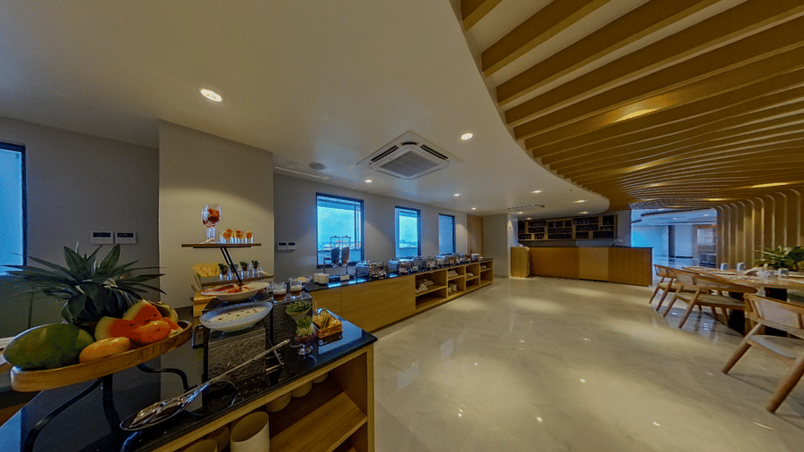 A dining area featuring its seating and fruit counter under lighting | Lords CBC Plaza, Chitwan