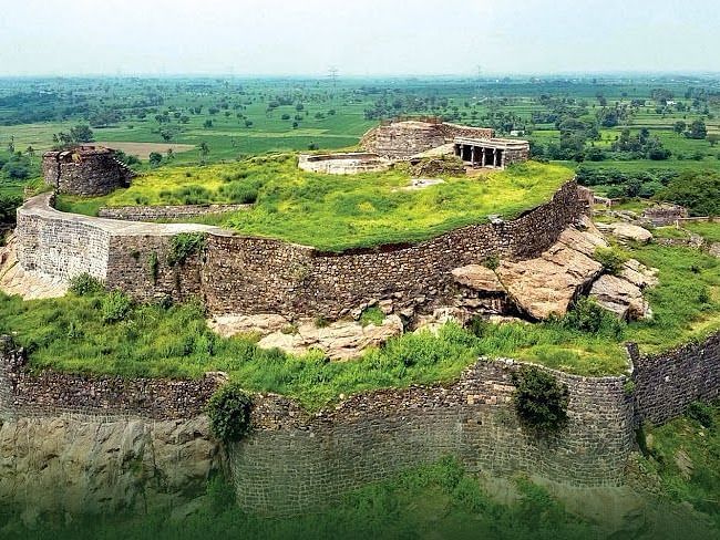 Aerial shot of ranjankundi fort surrounded by lush greenery