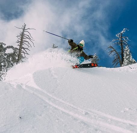 A person snowboarding down a snowy mountain slope.