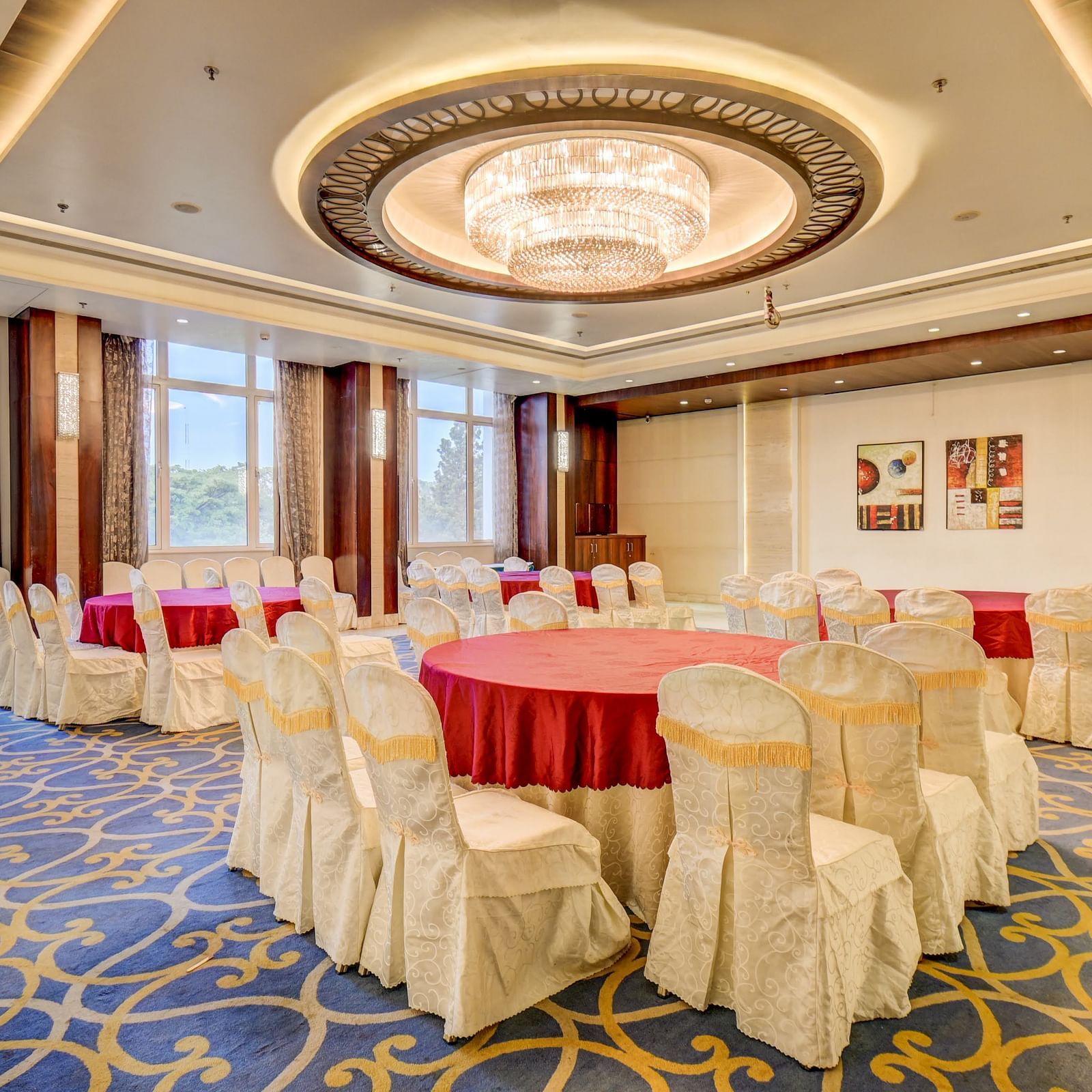 banquet hall with interior design and chairs at The SSK Solitaire Hotel & Banquets