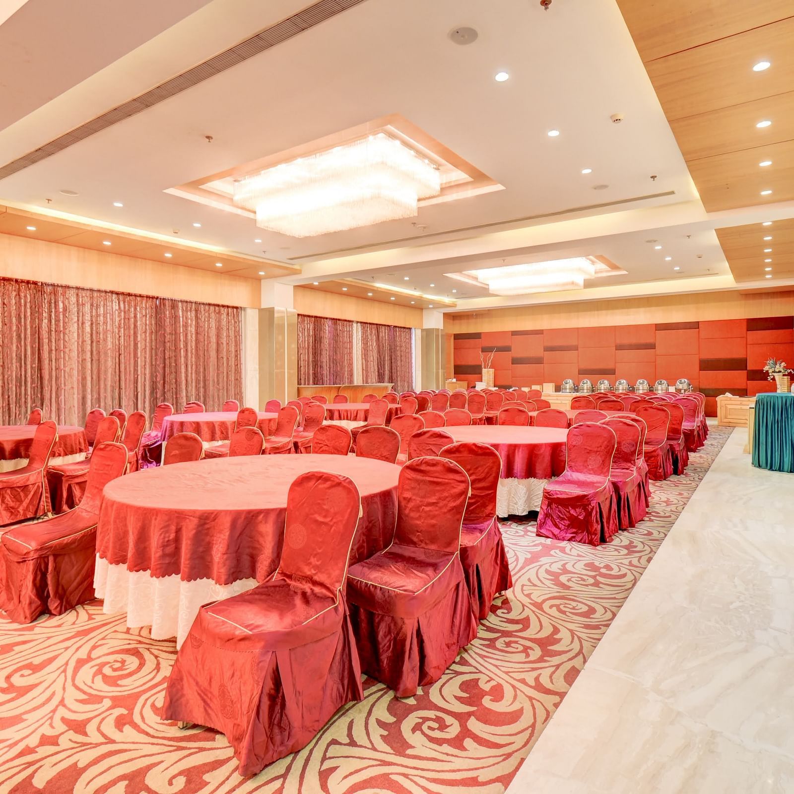 banquet hall with interior design and chairs at The SSK Solitaire Hotel & Banquets