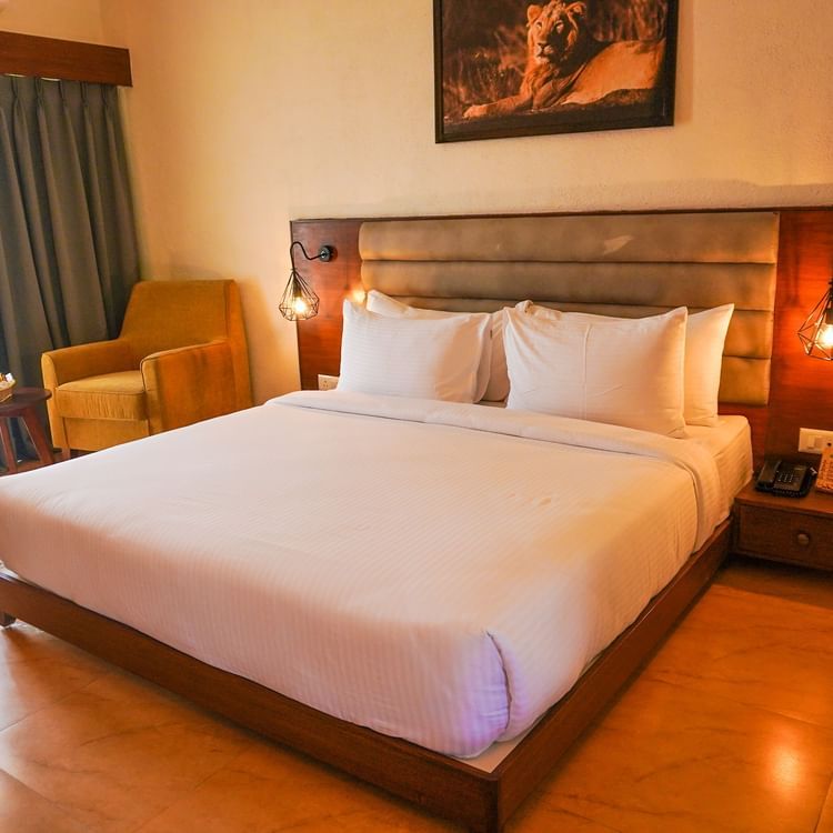 bedroom with white bed covers and other various other amenities at Jagira Ananta Elite 7