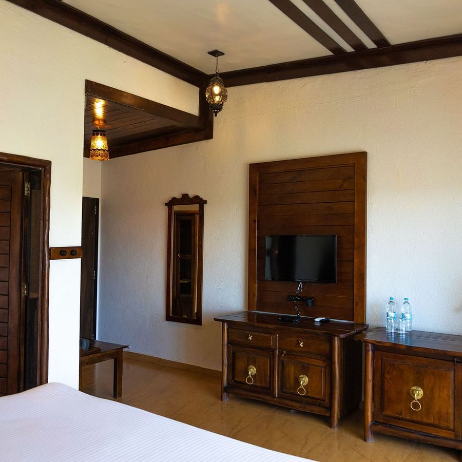 bedroom with white bed covers and other various other amenities at Jagira Ananta Elite 11