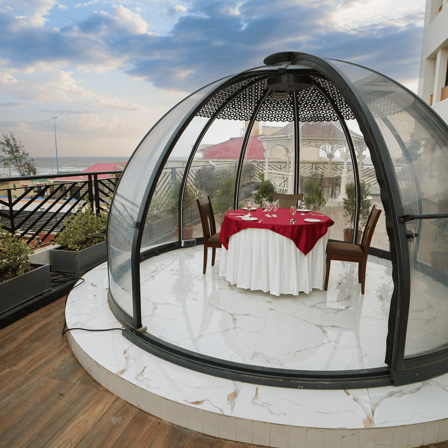 a half bubble kind of architecture with a table for two set inside it on the terrace at Shanti Seaview Resort & Spa - Hotels in Mandarmani Sea Facing