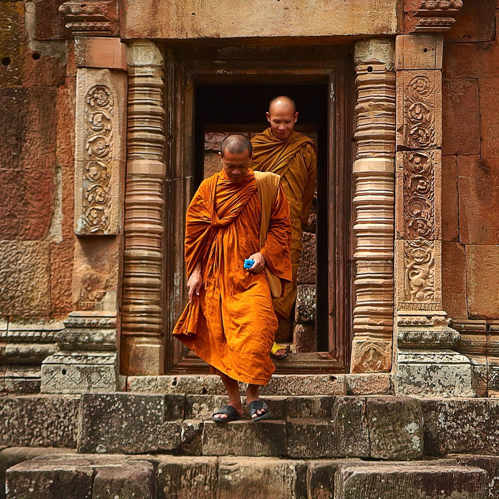 Two monks exiting a monastery